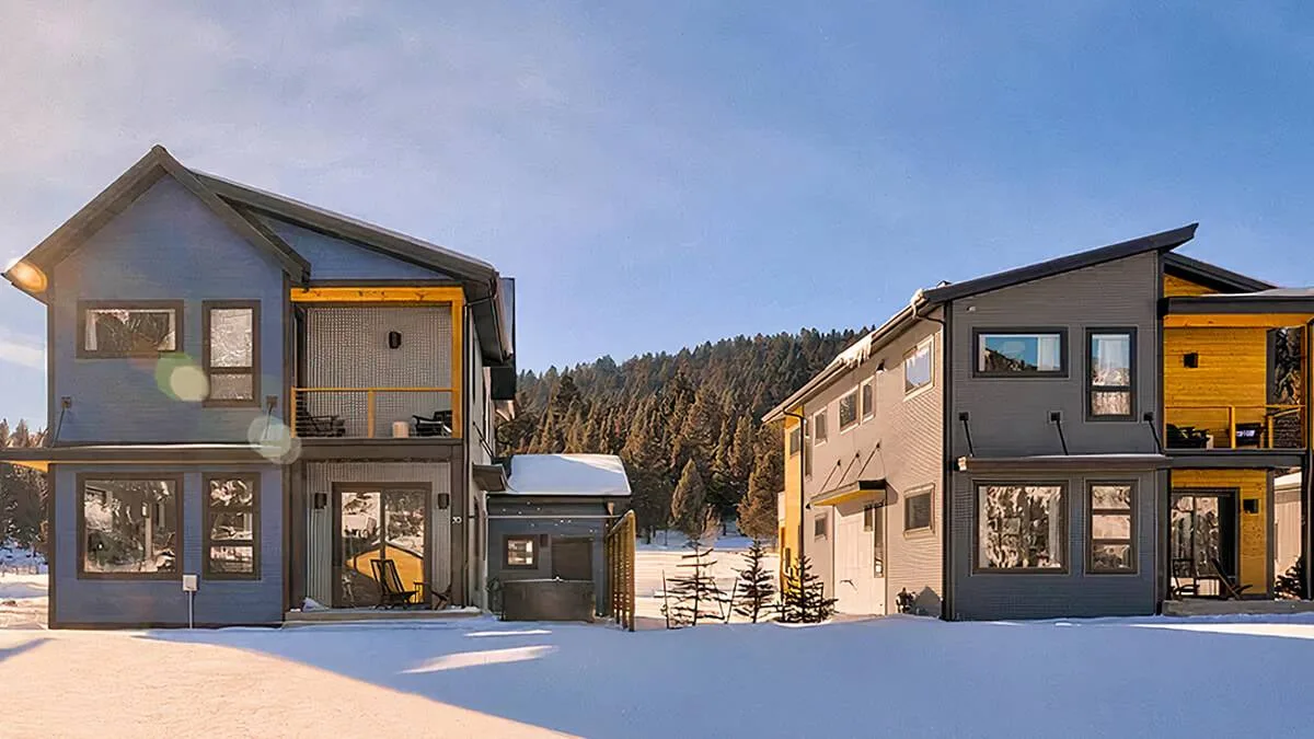 Two completed Irontown modular homes in a snowy mountain setting