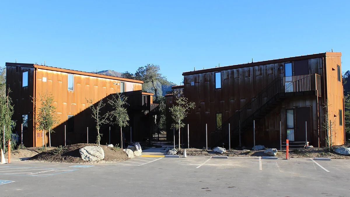 Two-story workforce housing building with wood-tone siding